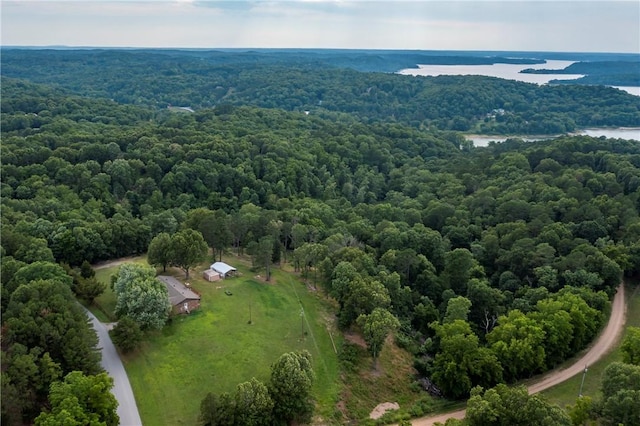 birds eye view of property with a water view and a view of trees