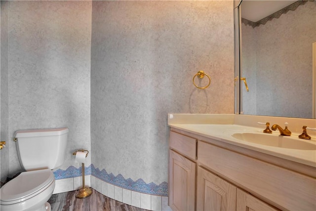 bathroom with vanity, wood finished floors, and toilet