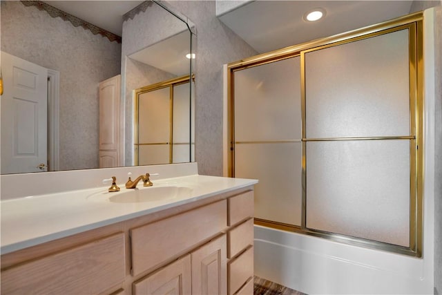 bathroom featuring vanity and combined bath / shower with glass door