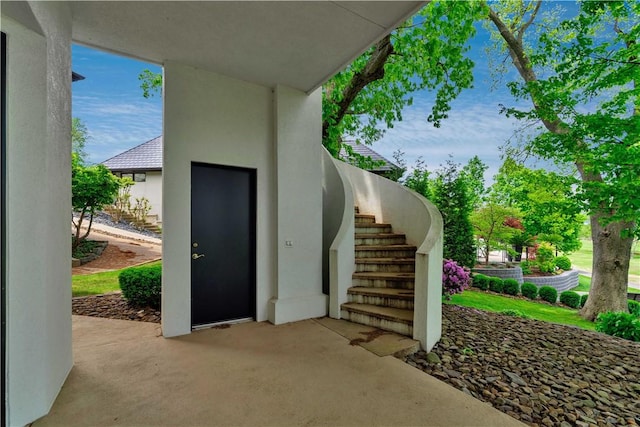 property entrance with a patio area and stucco siding