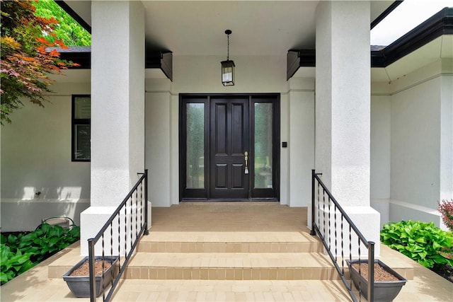 doorway to property featuring stucco siding and french doors