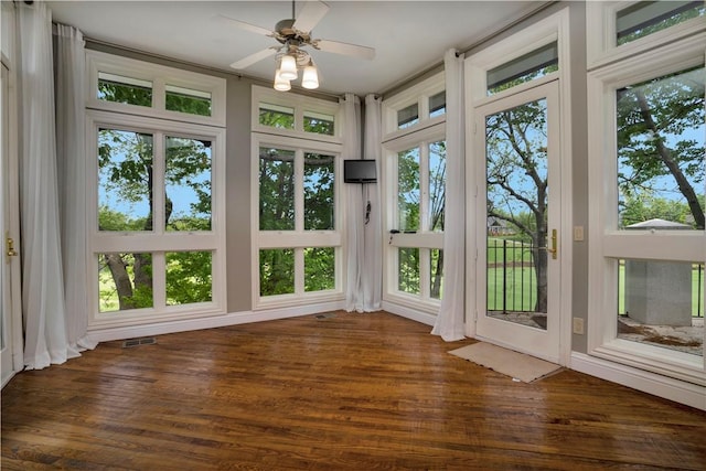unfurnished sunroom with visible vents and wood finished floors