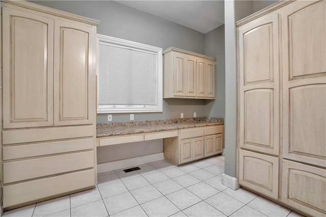 interior space featuring baseboards, visible vents, and tile patterned flooring