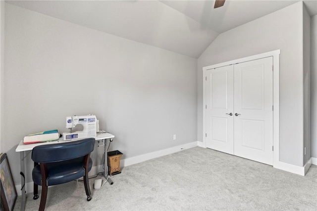 carpeted home office featuring a ceiling fan, baseboards, and vaulted ceiling