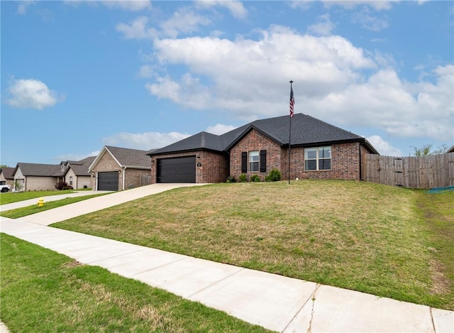 single story home with driveway, a garage, brick siding, fence, and a front lawn