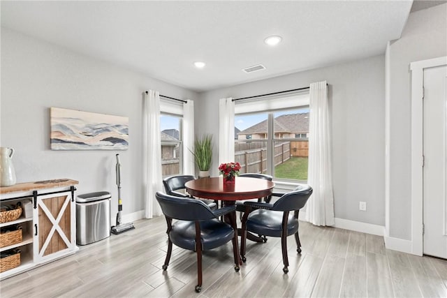 dining room featuring recessed lighting, baseboards, light wood finished floors, and visible vents