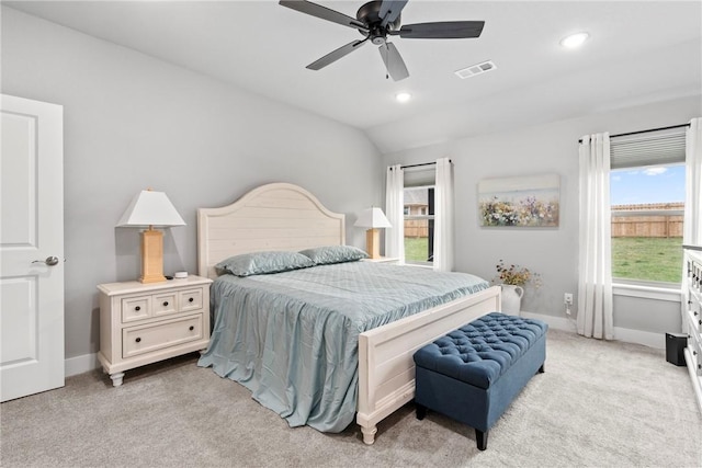 bedroom featuring visible vents, baseboards, lofted ceiling, and light carpet