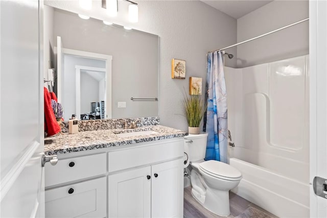 full bath featuring vanity, toilet, wood finished floors, and shower / tub combo