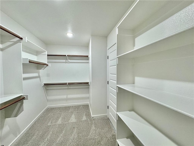 walk in closet with carpet