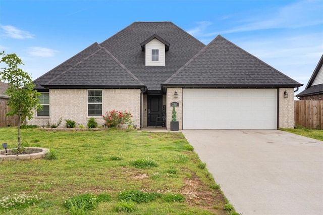 traditional-style home with fence, a front lawn, concrete driveway, an attached garage, and a shingled roof