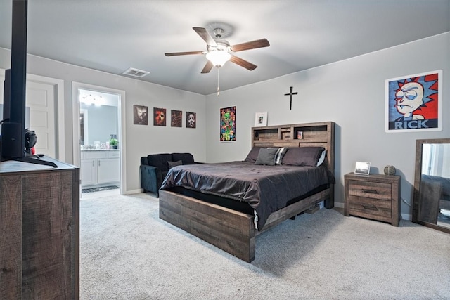 carpeted bedroom featuring visible vents, a ceiling fan, baseboards, and ensuite bath