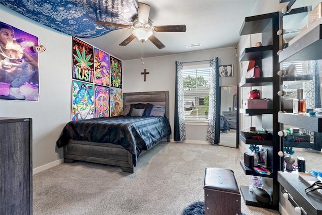 bedroom featuring baseboards, a ceiling fan, carpet flooring, and visible vents