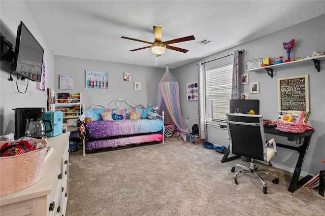 bedroom with carpet floors, a ceiling fan, and visible vents