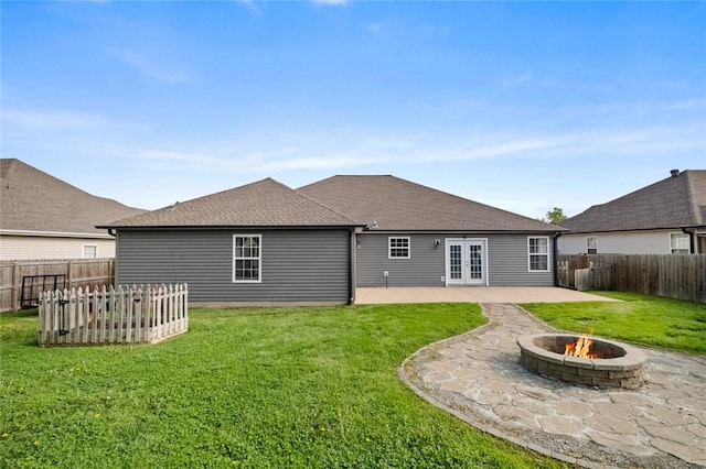 back of house featuring a yard, a patio, french doors, and an outdoor fire pit