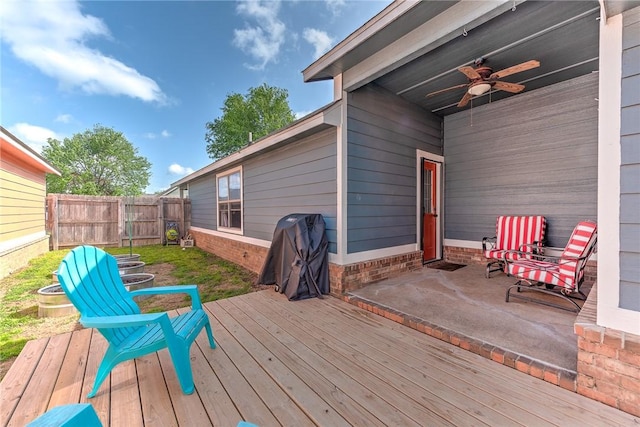 wooden terrace featuring fence and a ceiling fan