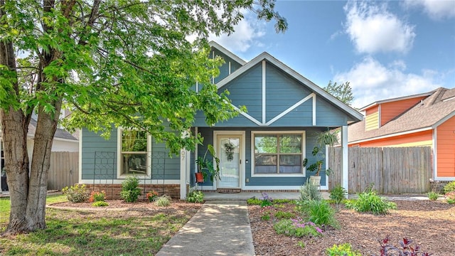 view of front of home with fence and covered porch