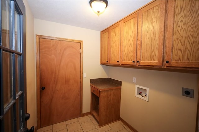 laundry room featuring cabinet space, hookup for a washing machine, electric dryer hookup, baseboards, and light tile patterned floors