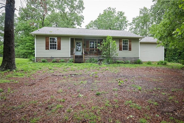 view of front of house featuring covered porch, crawl space, and roof with shingles