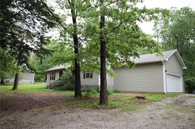 view of side of property featuring a garage and driveway