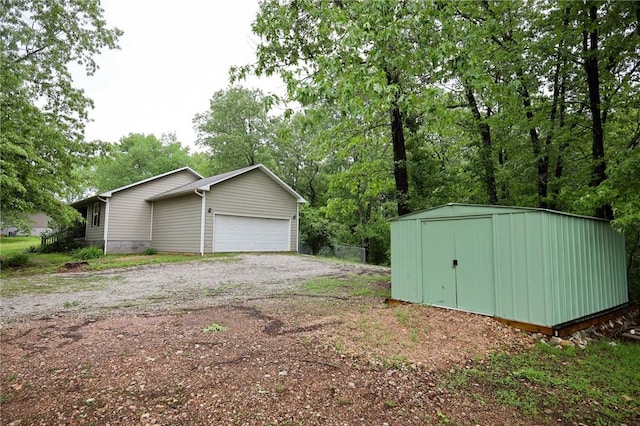 garage with a storage unit and driveway