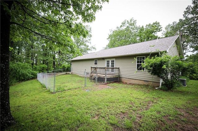 back of property featuring fence, a deck, crawl space, central AC unit, and a yard