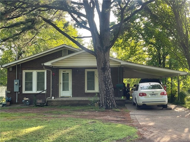 607 Carter St, Clarksville, AR 72830 - view of front of property featuring a front yard, brick siding, concrete driveway, a porch, and a carport