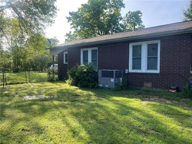 607 Carter St, Clarksville, AR 72830 - view of home's exterior featuring fence, a gate, a yard, and brick siding