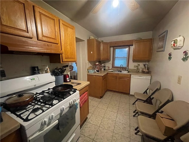 607 Carter St, Clarksville, AR 72830 - kitchen with a sink, white appliances, light countertops, light tile patterned floors, and under cabinet range hood