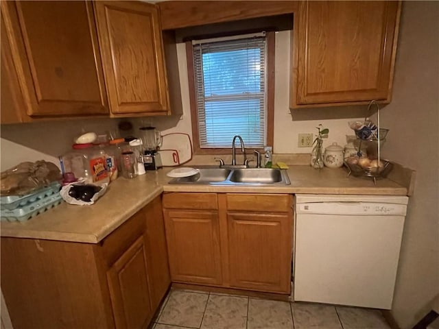 607 Carter St, Clarksville, AR 72830 - kitchen with white dishwasher, light countertops, light tile patterned floors, and a sink