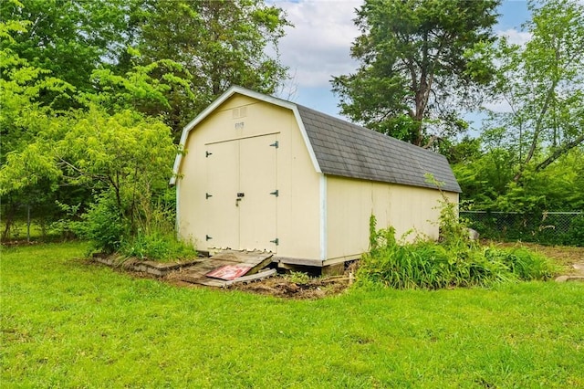 view of shed featuring fence
