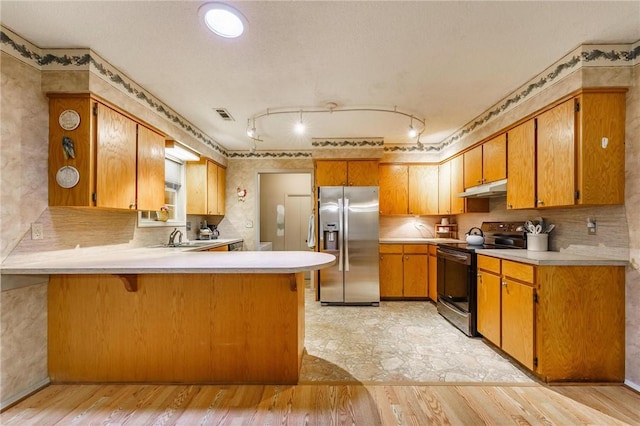 kitchen with black range with electric cooktop, a peninsula, light countertops, under cabinet range hood, and stainless steel fridge with ice dispenser