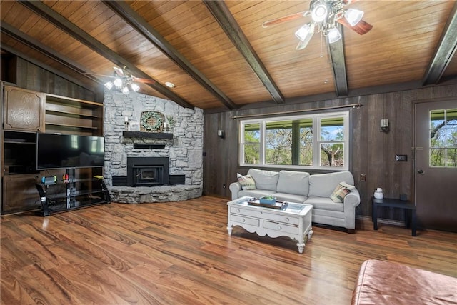 living area with a ceiling fan, wood finished floors, and wood ceiling