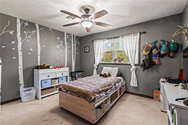 bedroom featuring a ceiling fan, a textured ceiling, light colored carpet, and visible vents
