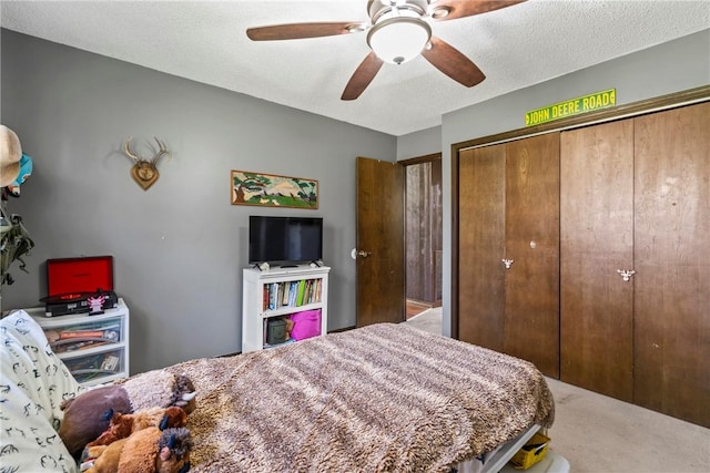 carpeted bedroom featuring a closet and ceiling fan