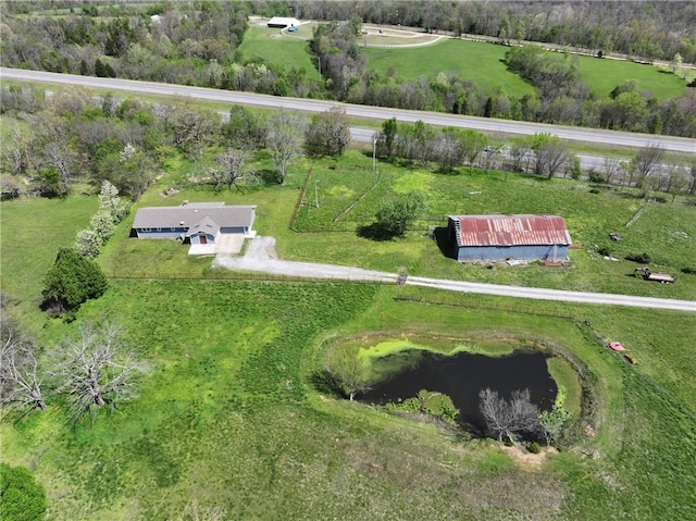 birds eye view of property featuring a water view and a rural view