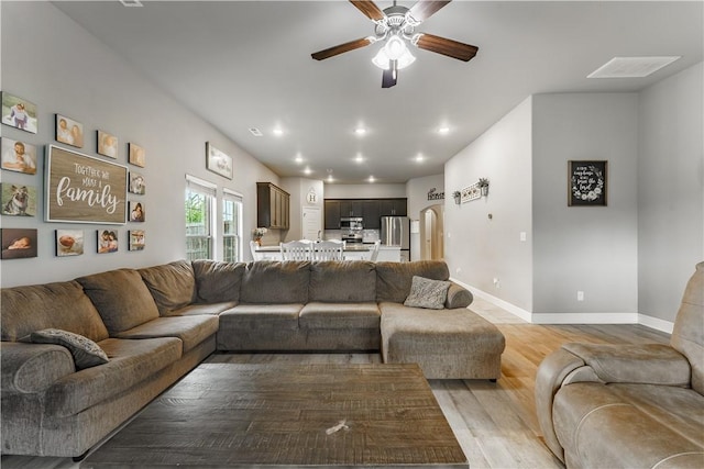 living area with visible vents, light wood-style floors, baseboards, ceiling fan, and recessed lighting