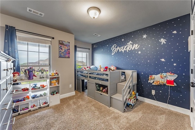 bedroom with visible vents, baseboards, carpet floors, and wallpapered walls