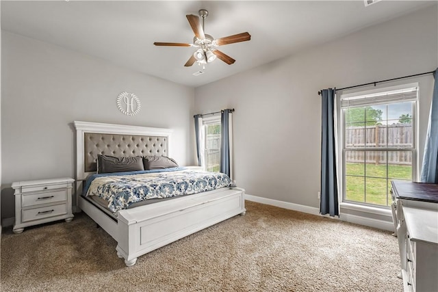 bedroom with ceiling fan, baseboards, and carpet