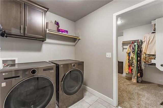 laundry room with cabinet space, independent washer and dryer, baseboards, and light colored carpet