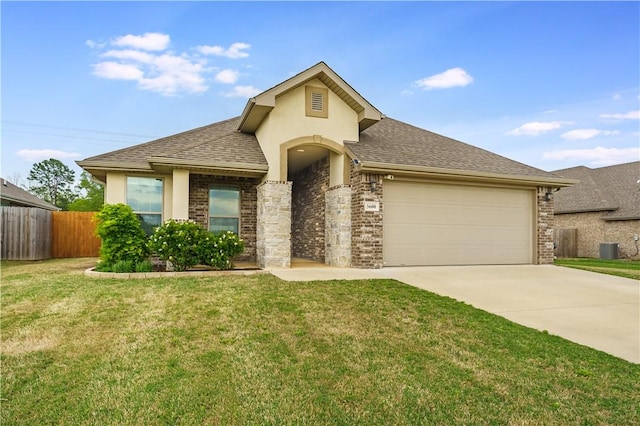 single story home with fence, driveway, a front lawn, and a garage