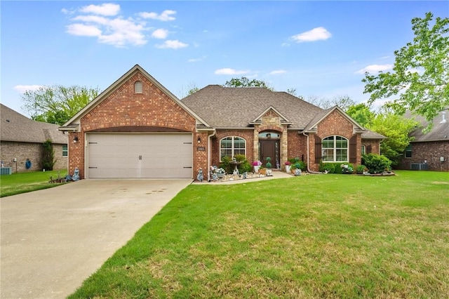 single story home featuring a front yard, a garage, brick siding, central AC, and concrete driveway