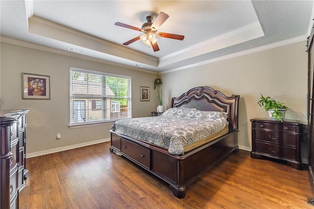 bedroom featuring a raised ceiling, ornamental molding, and visible vents