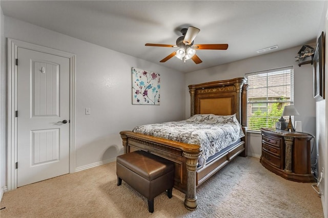 bedroom with baseboards, light carpet, a ceiling fan, and visible vents
