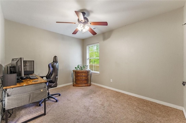 office area with baseboards, a ceiling fan, and carpet
