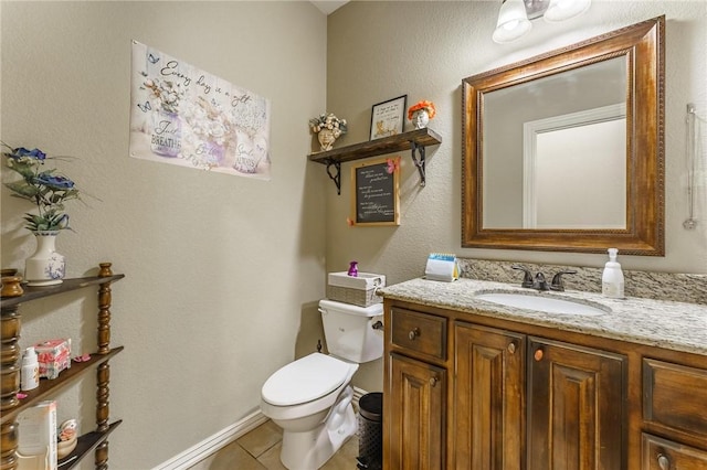 bathroom featuring toilet, tile patterned flooring, and vanity