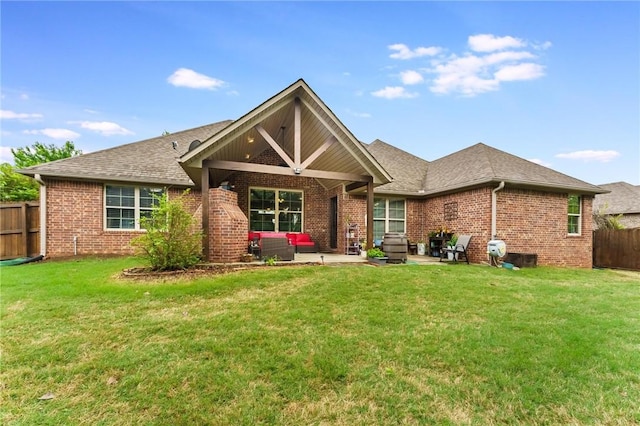 view of front of property featuring brick siding, fence, an outdoor hangout area, a front lawn, and a patio