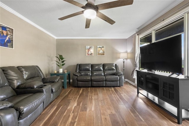 living area with crown molding, a ceiling fan, and hardwood / wood-style floors