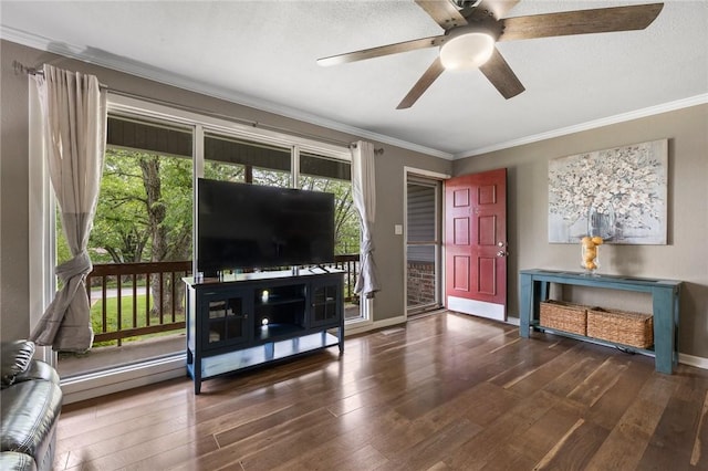 living room featuring wood-type flooring, ornamental molding, baseboards, and ceiling fan