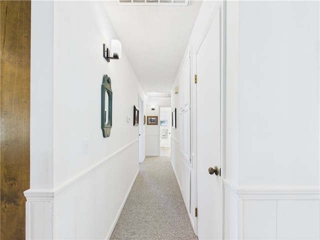 corridor with visible vents and light carpet