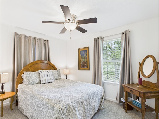bedroom with ceiling fan, light colored carpet, and baseboards